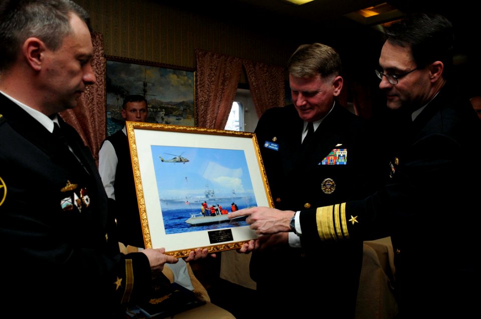 US Navy 100510-N-8721D-003 Vice Adm. John M. Bird and Capt. Rudy Lupton present Capt. 1st Rank Eduard Moskalenko with a gift during a tour of the Russian ship