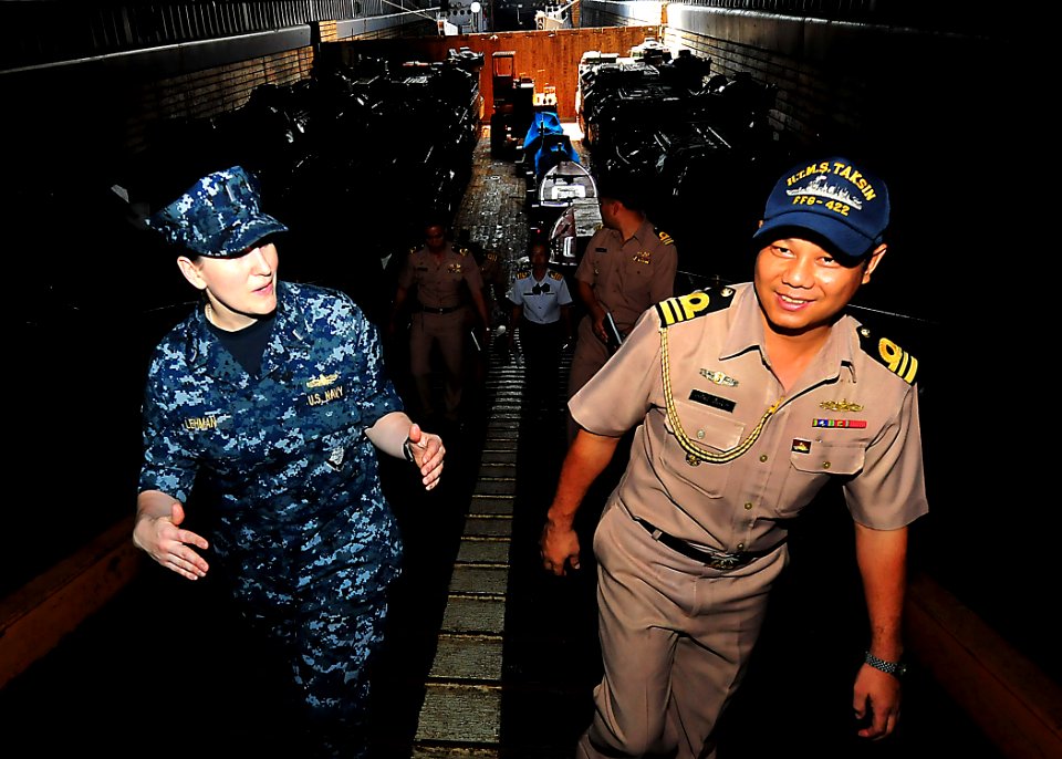 US Navy 100511-N-7643B-113 Lt. j.g. Theresa Lehman explains well deck operations aboard the amphibious dock landing ship USS Tortuga (LSD 46) to a Royal Thailand Navy officer