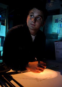US Navy 100510-N-1082Z-024 Operations Specialist Seaman John J. McNulty, from North Brunswick, N.J., observes the time as he plots points on the dead reckoning tracer aboard the amphibious dock landing ship USS Ashland (LSD 48)