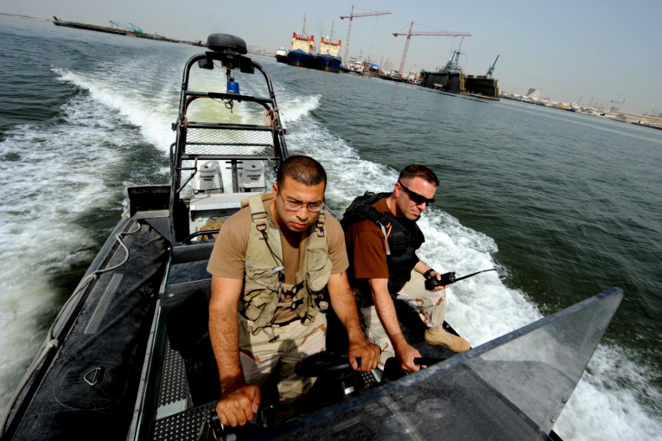 US Navy 100512-N-6463B-017 Chief Master-at-Arms Brandon Parks and Boatswain's Mate 2nd Class Hugo Escobar maintain port security along U.S. and coalition force piers in Bahrain