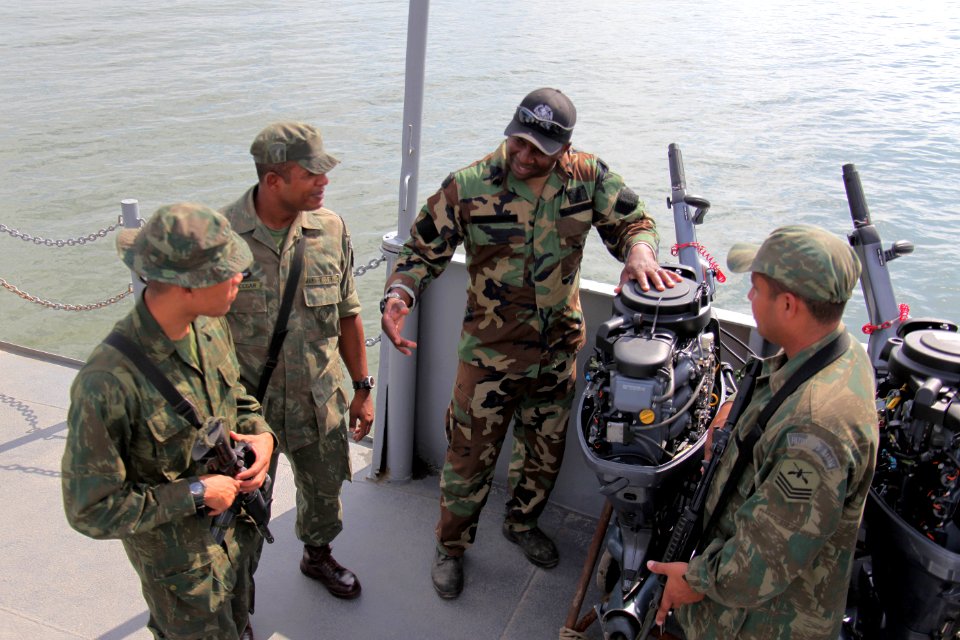 US Navy 100512-N-4205W-145 A U.S. Navy special warfare combatant-craft crewman explains the maintenance procedures of an outboard motor to members of the Brazilian Marine Corps Special Operations Battalion