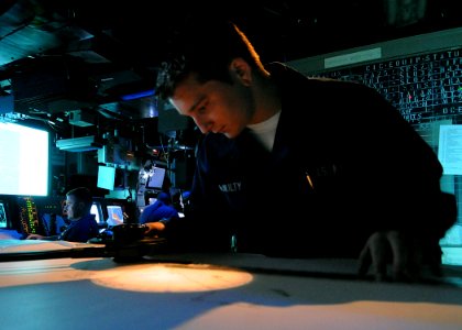 US Navy 100513-N-1082Z-001 Operations Specialist Seamen John Mcnulty, from North Brunswick New Jersey, plots a fix on the dead reckoning tracer aboard the amphibious dock landing ship USS Ashland (LSD 48)