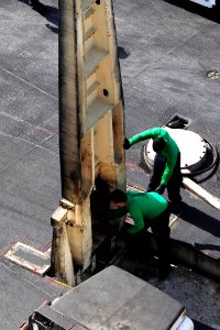 US Navy 100511-N-6604E-060 Sailors aboard the aircraft carrier USS Dwight D. Eisenhower (CVN 69) remove a barricade stanchion brace after inspecting for foreign object debris