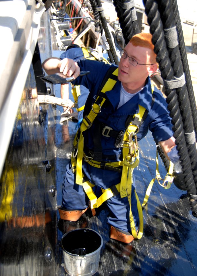 US Navy 100513-N-2319A-166 Aviation Maintenance Administrationman Airman Dylan Roberts paints the side of USS Constitution