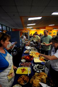 US Navy 100511-N-6046S-088 Navy personnel and families eat a free dinner during the monthly We Care Supper