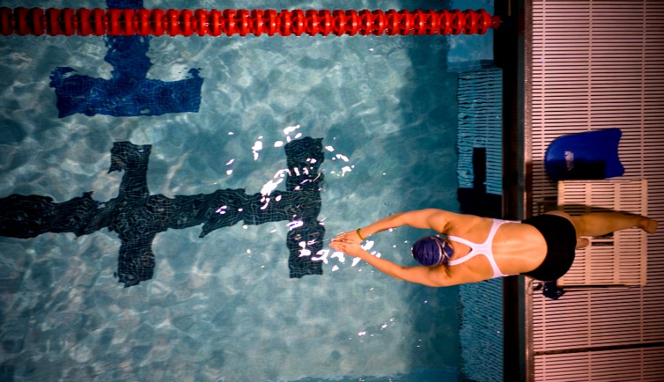 US Navy 100511-N-6932B-111 Lt. Melanie Monts de Oca, a Navy competitor, dives off a platform while practicing for her upcoming swimming competitions