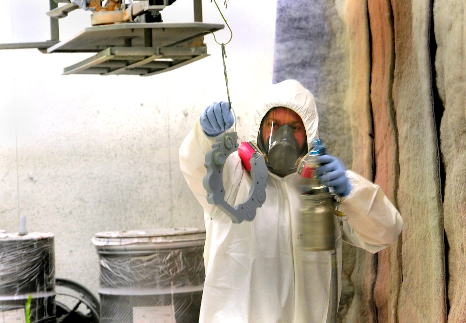 US Navy 100513-N-3262C-020 Aviation Structural Mechanic 2nd Class Jacob Buzby, assigned to Fleet Readiness Center Southwest, paints a brake housing for an SH-60F Sea Hawk helicopter