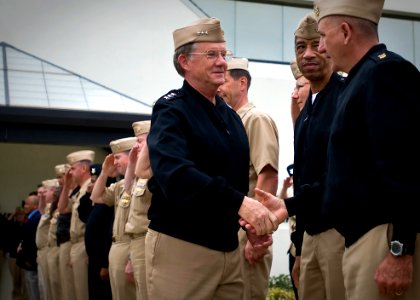US Navy 100513-N-0807W-018 Vice Adm. H. Denby Starling II, commander of Navy Cyber Forces and Naval Network Warfare Command, shakes hands with Force Master Chief Jay Powers as he departs his office for the last time at Joint Ex photo