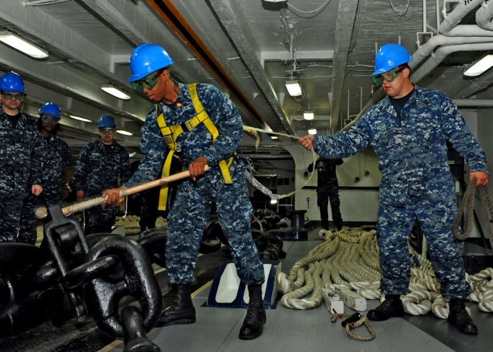 US Navy 100511-N-4516G-107 Seaman Christopher F. Peggins releases a riding stopper from a starboard-side anchor chain