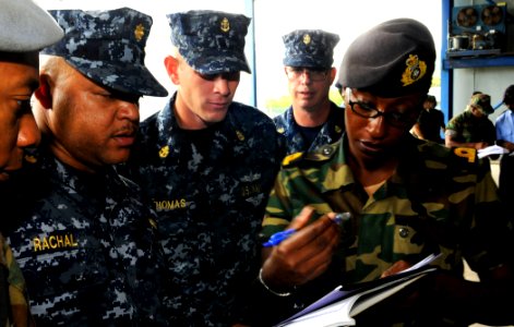US Navy 100510-N-9643W-024 Jamaica Defense Force Coast Guard National Reserve Sub Lt. Althia White, completes paperwork to participate in subject matter exchanges before boarding High Speed Vessel Swift (HSV 2) photo