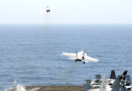 US Navy 100511-N-4236E-370 Two F-A-18F Super Hornets assigned to Jolly Rogers of strike fighter squadron (VFA) 103 launch from the aircraft carrier USS Dwight D. Eisenhower (CVN 69)