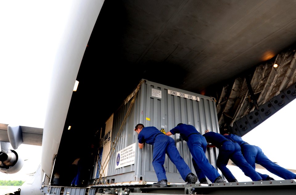 US Navy 100511-N-9712C-003 Sailors unload oil containment equipment from an Air Force C-17 transport aircraft at Naval Air Station Joint Reserve Base New Orleans