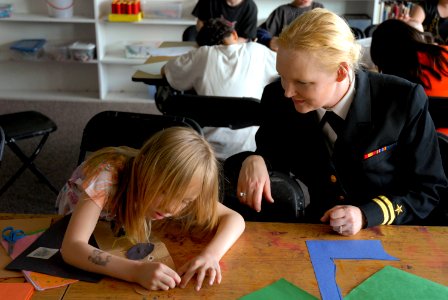 US Navy 100512-N-0869H-119 Lt. Victoria Tobin, assigned to the Navy Office of Community Outreach, watches a member of the Boys and Girls Club of Spokane County during a Spokane Navy Week event photo