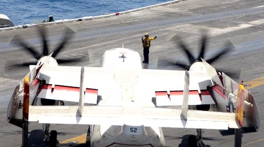 US Navy 100511-N-4236E-199 A Sailor directs a C-2A Greyhound assigned to the Rawhides of Fleet Logistics Support Squadron (VRC) 40 aboard the aircraft carrier USS Dwight D. Eisenhower (CVN 69)