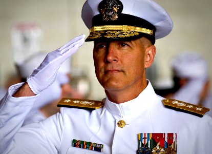 US Navy 100514-N-0807W-231 Rear Adm. Tom Meek salutes as he is piped aboard during a change of command ceremony at Joint Expeditionary Base Little Creek-Fort Story