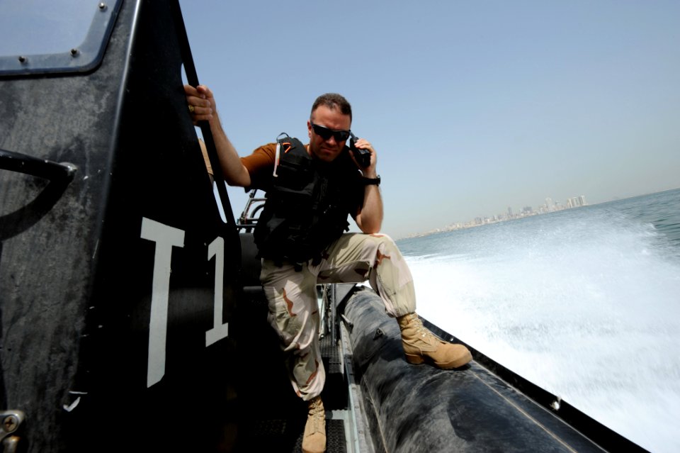 US Navy 100512-N-6463B-031 Chief Master-at-Arms Brandon Parks and Boatswain's Mate 2nd Class Hugo Escobar maintain port security along U.S. and coalition force piers in Bahrain