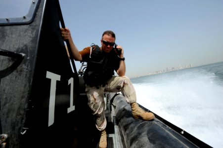 US Navy 100512-N-6463B-031 Chief Master-at-Arms Brandon Parks and Boatswain's Mate 2nd Class Hugo Escobar maintain port security along U.S. and coalition force piers in Bahrain photo