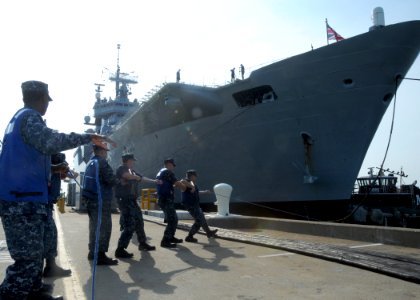 US Navy 100514-N-6764G-042 Line handlers secure mooring lines from the Royal Navy Invincible-class light aircraft carrier HMS Ark Royal (RO7) as it arrives at Naval Station Norfolk