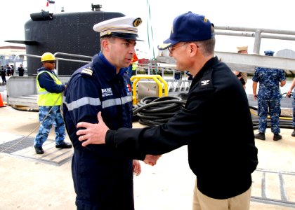 US Navy 100511-N-7705S-090 Capt. Chris Thomas greets Cmdr. Christian Houette following his arrival at Naval Station Norfolk