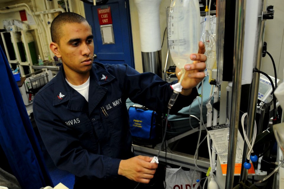 US Navy 100515-N-4516G-007 Hospital Corpsman 3rd Class Jonathan L. Rivas checks a patient's intravenous bag aboard the aircraft carrier USS Enterprise (CVN 65)