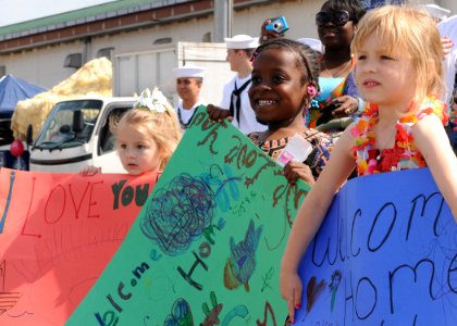 US Navy 100512-N-5538K-077 Children of Sailors assigned to the mine countermeasures ship USS Patriot (MCM 7) wait as the ship moors