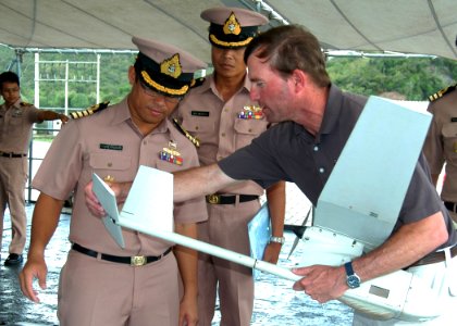 US Navy 100516-N-3446M-024 Paul Trist Jr., right, a civilian flight demonstration manager, shows Royal Thai Navy officers how to install the tail rudder on the Puma AE mini-unmanned aerial vehicle