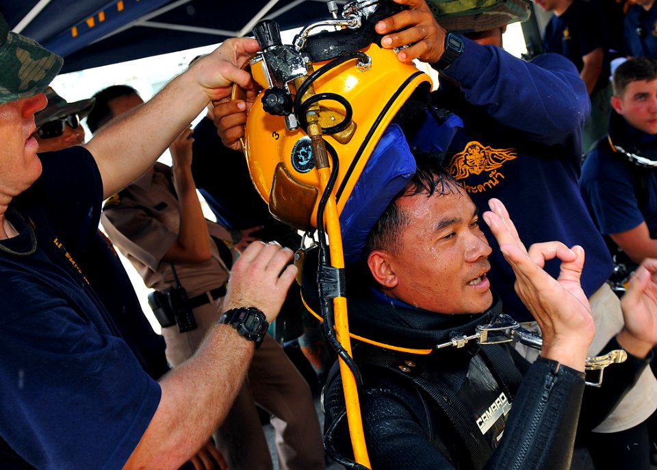 US Navy 100515-N-7643B-181 U.S. Navy Divers take the MK-21 diving helmet off Royal Thai Navy diver Petty Officer 1st Class Sarawut after completing a Cooperation Afloat Readiness and Training (CARAT) Thailand 2010 training dive