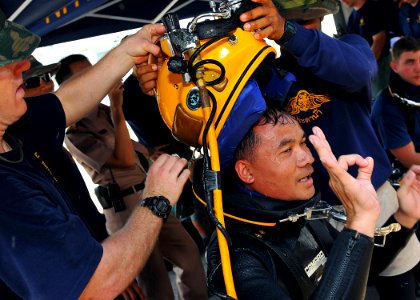US Navy 100515-N-7643B-181 U.S. Navy Divers take the MK-21 diving helmet off Royal Thai Navy diver Petty Officer 1st Class Sarawut after completing a Cooperation Afloat Readiness and Training (CARAT) Thailand 2010 training dive