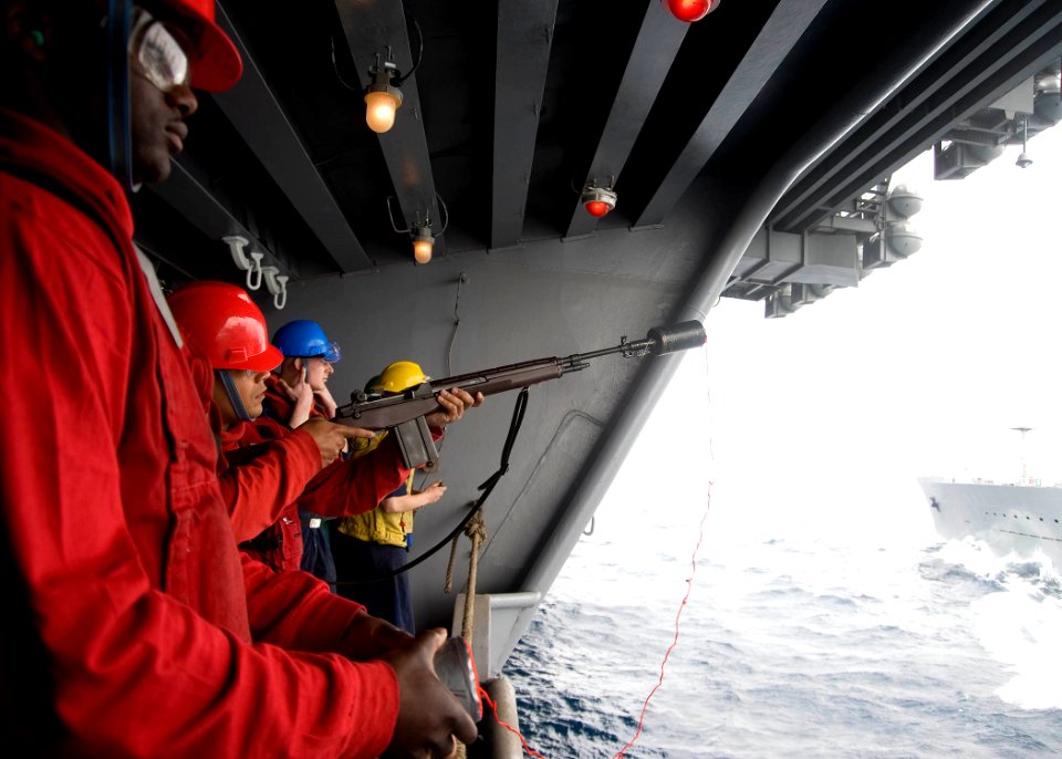 US Navy 100512-N-7191M-028 Gunner's Mate 3rd Class Ramon Quinones prepares to fire a receiving line from the aircraft carrier USS George Washington (CVN 73) to the Military Sealift Command fleet replenishment oiler USNS Walter
