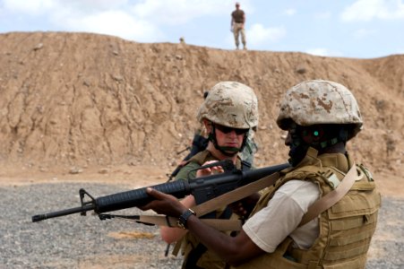 US Navy 100512-N-7526R-113 A Marine shows an Ethiopian officer proper procedures for firing an M-16 service rifle photo