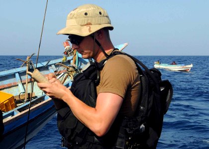 US Navy 100513-N-1082Z-020 Electronics Technician 2nd Class Benjamin E. O'Quinn takes notes while conducting maritime security operations photo