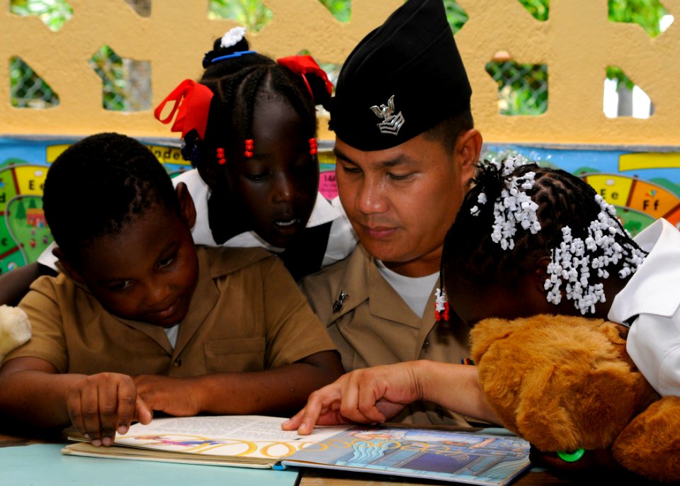 US Navy 100512-N-4971L-368 A Sailor plays with children during a Project Handclasp donation