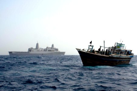 US Navy 100514-N-3358S-295 The amphibious transport dock ship USS Mesa Verde (LPD 19) waits in the distance as a team of Sailors go aboard a disabled dhow