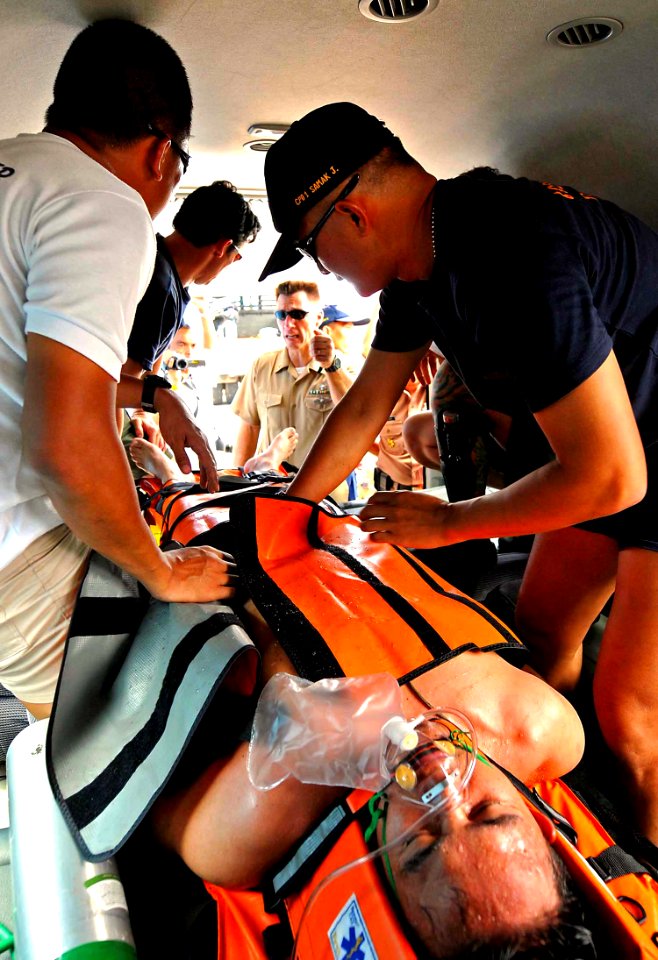 US Navy 100518-N-7643B-223 enior Chief Hospital Corpsman Michael J. Sam directs Royal Thai Navy divers and medical officers on emergency evacuation procedures after a dive near USCGC Mellon (WHEC 717)
