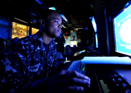 US Navy 100513-N-5082P-008 Operations Specialist 3rd Class Gregory L. Gray mans his station in the Combat Direction Center aboard the aircraft carrier USS Enterprise (CVN 65)