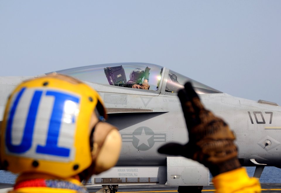 US Navy 100518-N-4236E-220 Aviation Boatswain's Mate Handling 2nd Class Zach Cheatham signals the pilot of an F-A-18E Super Hornet assigned to the Pukin Dogs of Strike Fighter Squadron (VFA) 143 before catapulting from the airc