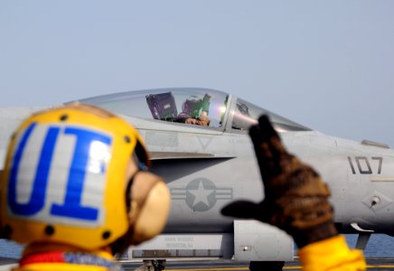 US Navy 100518-N-4236E-220 Aviation Boatswain's Mate Handling 2nd Class Zach Cheatham signals the pilot of an F-A-18E Super Hornet assigned to the Pukin Dogs of Strike Fighter Squadron (VFA) 143 before catapulting from the airc