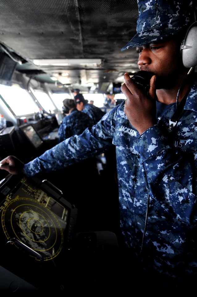 US Navy 100518-N-9132C-090 Operation Specialist Seaman Dale Jackson communicates from the bridge with all watch stations aboard USS Ronald Reagan (CVN 76)
