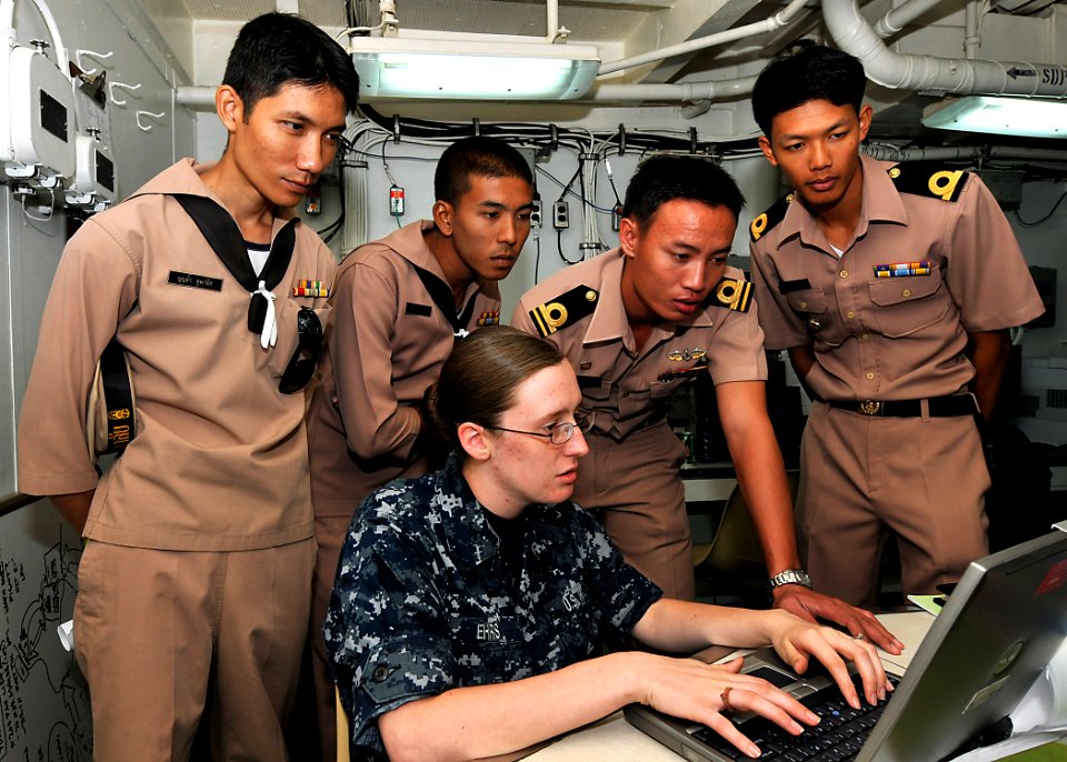 US Navy 100514-N-7643B-004 Information Systems Technician Seaman Katelynn L. Ehrs discusses network and communication training with Royal Thai Navy sailors aboard USS Tortuga (LSD 46)