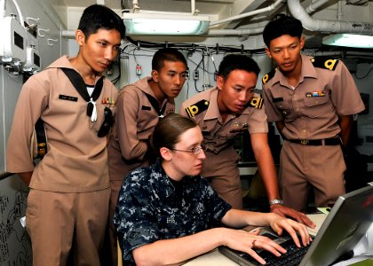 US Navy 100514-N-7643B-004 Information Systems Technician Seaman Katelynn L. Ehrs discusses network and communication training with Royal Thai Navy sailors aboard USS Tortuga (LSD 46)
