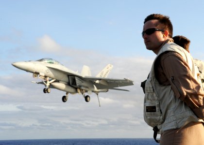 US Navy 100513-N-3620B-085 Lt. Elliott Shoup watches as an F-A-18F Super Hornet assigned to VFA-11 performs an arrested landing aboard the USS Enterprise (CVN 65)