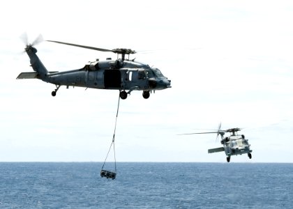 US Navy 100513-N-6720T-014 Two MH-60S Sea Hawk helicopters transport ordnance to the aircraft carrier USS George Washington (CVN 73)