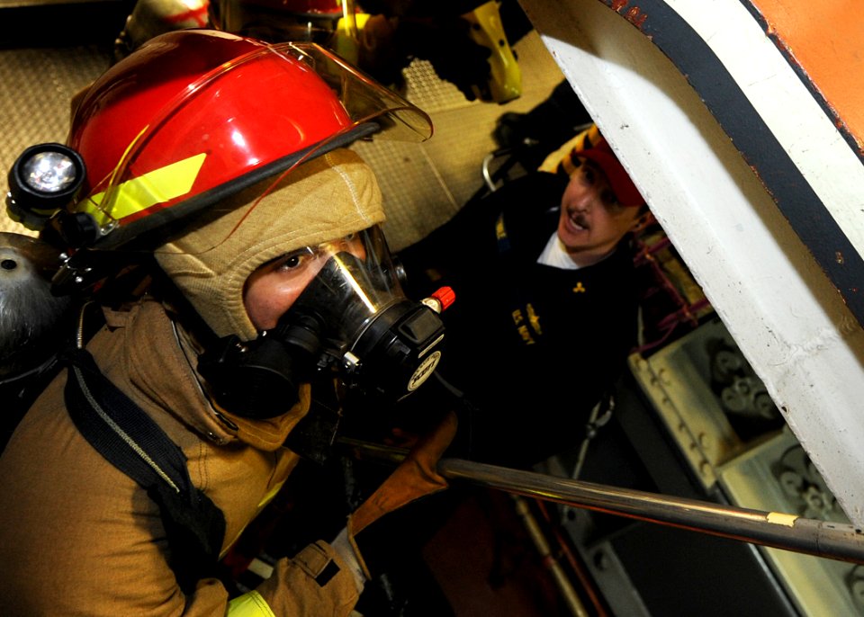 US Navy 100514-N-5082P-028 A member of the at-sea fire party passes the word to the messenger during a class bravo fire drill