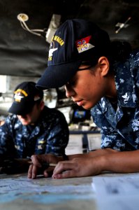 US Navy 100518-N-9132C-089 Quarter Master 2nd Class Melissa Pate plots a course as USS Ronald Reagan (CVN 76) pulls out of San Diego Harbor