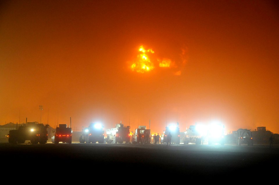US Navy 100517-N-0475R-486 Emergency vehicles line the perimeter of a fire at a supply area at Camp Leatherneck
