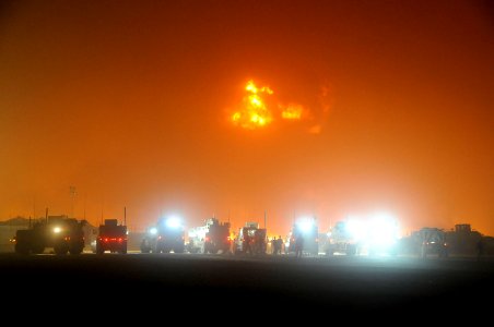 US Navy 100517-N-0475R-486 Emergency vehicles line the perimeter of a fire at a supply area at Camp Leatherneck photo