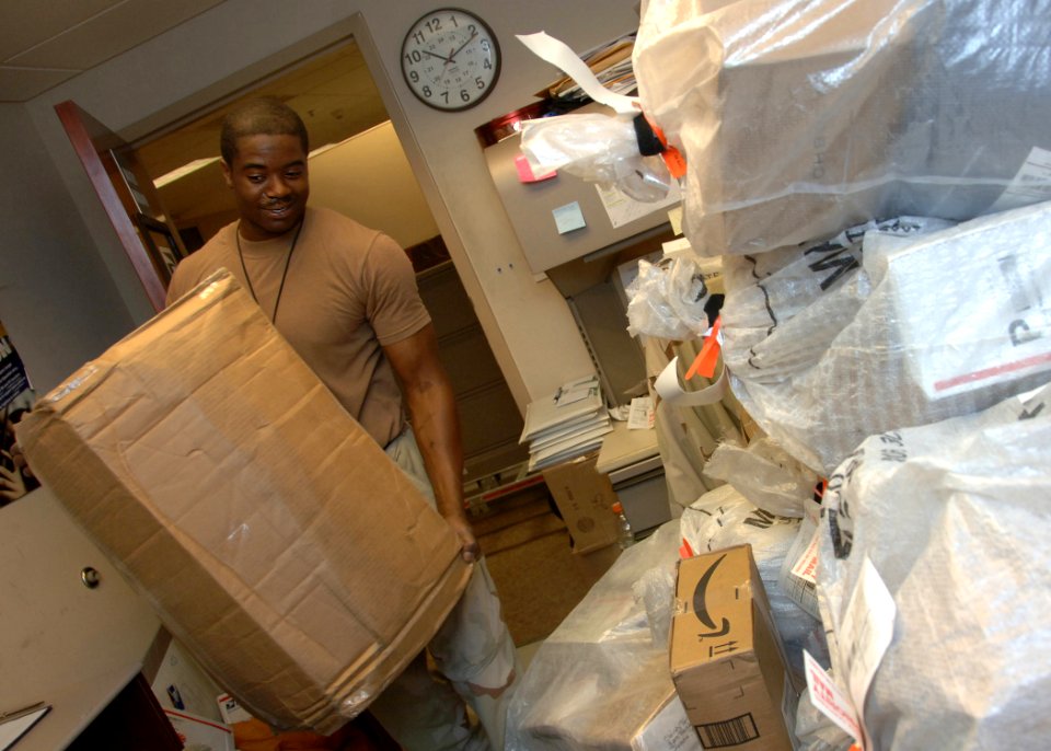 US Navy 100516-N-5821P-001 Logistics Specialist 3rd Class Thomas Harrison orts mail at the U.S. Naval Forces Central Command mail room at Naval Support Activity, Bahrain