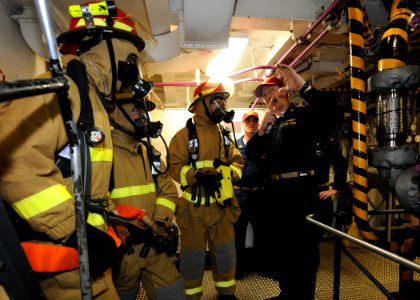 US Navy 100514-N-5082P-037 Sailors assigned to the at-sea fire party discuss their performance after a class bravo fire drill