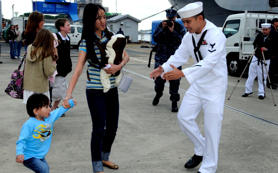 US Navy 100514-N-7478G-133 Ship's Serviceman 3rd Class Archie Burdeos greets his family and newborn child during the U.S. 7th Fleet command ship USS Blue Ridge (LCC 19) homecoming