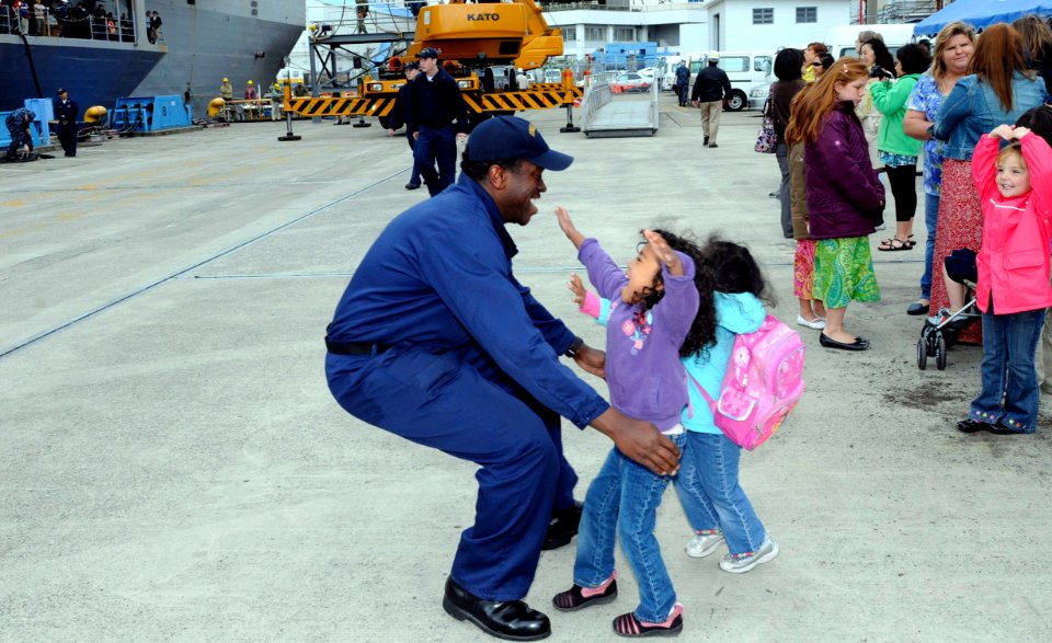 US Navy 100514-N-7478G-135 Information Systems Technician 1st Class Melvin McCullough greets his daughters during the U.S. 7th Fleet command ship USS Blue Ridge (LCC 19) homecoming